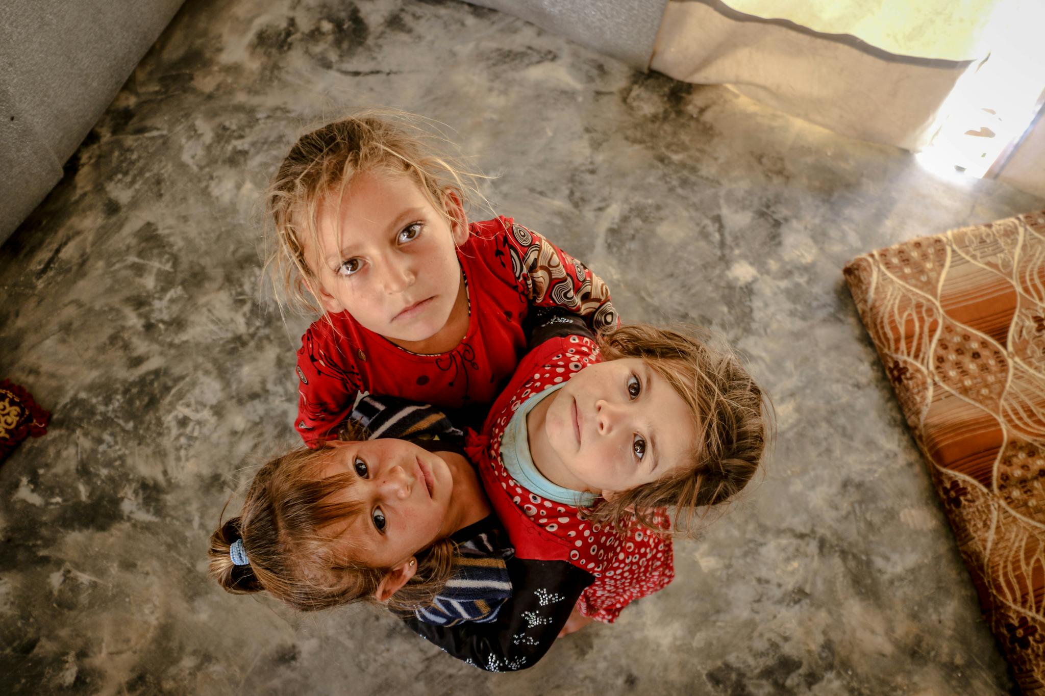 A Photo of Three Kids Looking Up